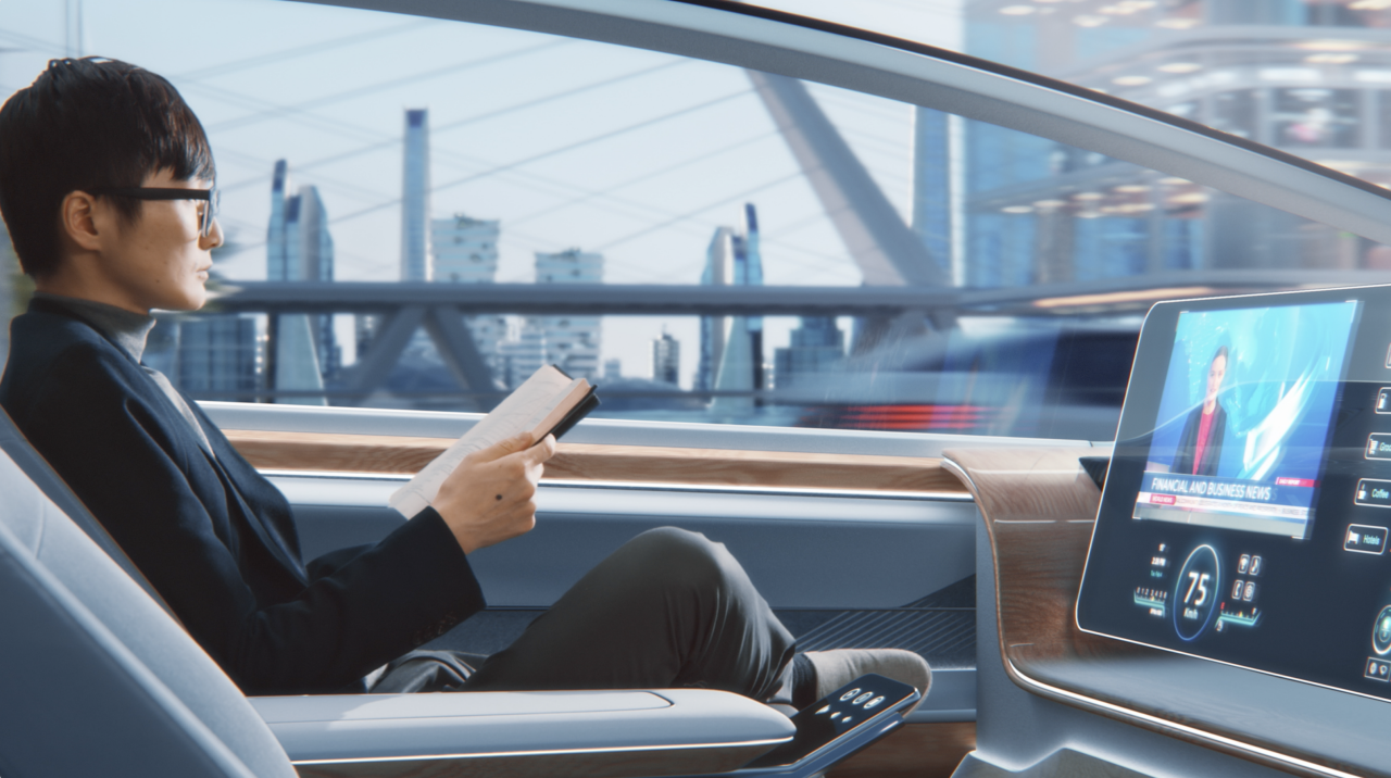 Man holding a book while traveling in an ultra-tech car
