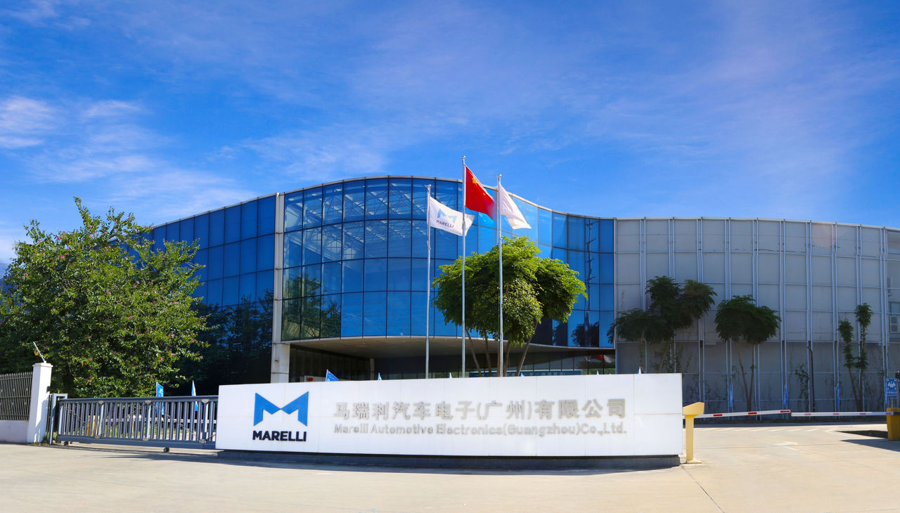 Exterior view of Marelli Automotive Electronics factory in Guangzhou with glass building and company signage.