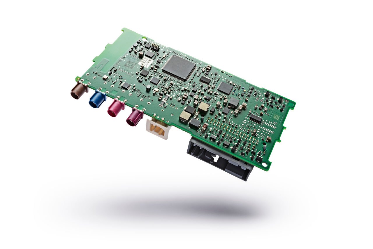 Marelli automotive electronic control board with integrated processors and connectors.