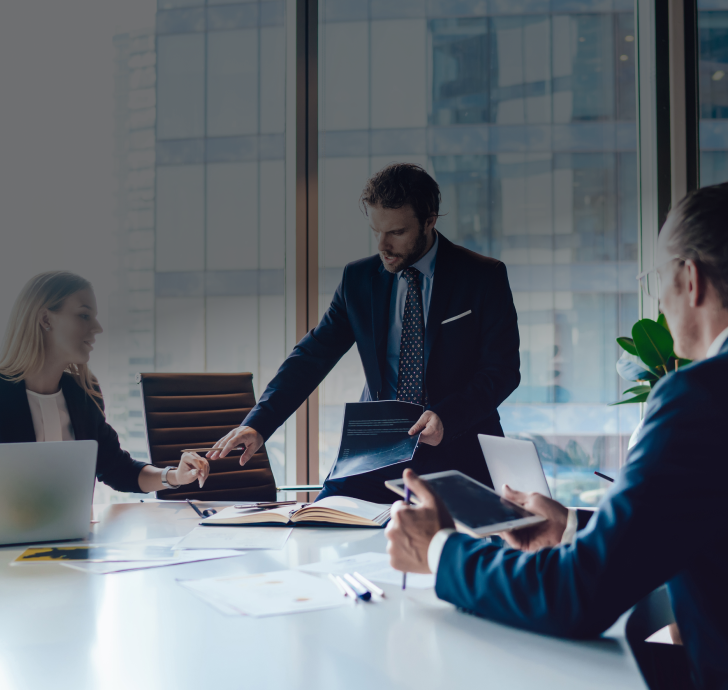 Professional financial experts discussing details of report during cooperation in office interior, mature male and female corporate directors brainstorming togetherness on information near desktop.